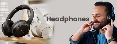 Saif enjoying music with Bluetooth wireless headphones, alongside black and white over-ear Boult's wireless headphones displayed on a table.